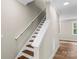 Staircase with wood treads and white risers leads to a room with natural light and a view of the outdoors at 2668 Polo Ln, Maiden, NC 28650