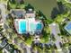 Aerial view highlighting a community pool with lounge chairs and tennis courts near a picturesque pond at 2684 Sunberry Nw Ln, Concord, NC 28027