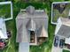 Aerial view of a well-maintained home with a manicured lawn, landscaped garden beds, and a driveway at 2684 Sunberry Nw Ln, Concord, NC 28027