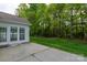 Backyard featuring a concrete patio and view of the lawn, garden, and wooded area beyond at 2684 Sunberry Nw Ln, Concord, NC 28027