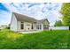 View of backyard featuring a well-maintained lawn, concrete patio, sunroom, and partially fenced in area at 2684 Sunberry Nw Ln, Concord, NC 28027