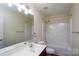 Bathroom featuring a shower-tub combo and modern vanity with a large mirror at 2684 Sunberry Nw Ln, Concord, NC 28027