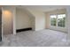Carpeted bedroom featuring natural light from windows, with neutral walls and a closet at 2684 Sunberry Nw Ln, Concord, NC 28027