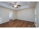 Spacious bedroom featuring hardwood floors, trey ceilings, ceiling fan, and en-suite bathroom access at 2684 Sunberry Nw Ln, Concord, NC 28027