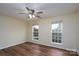 Bedroom featuring hardwood floors, neutral wall color and natural light from two windows at 2684 Sunberry Nw Ln, Concord, NC 28027
