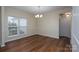 Dining room featuring neutral colors, a modern chandelier, and ample natural light at 2684 Sunberry Nw Ln, Concord, NC 28027
