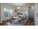 Dining room featuring neutral colors, a modern chandelier, and ample natural light at 2684 Sunberry Nw Ln, Concord, NC 28027