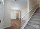 Inviting entryway with wood floors, a staircase, and neutral paint, creating a warm and welcoming ambiance at 2684 Sunberry Nw Ln, Concord, NC 28027