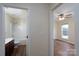 Inviting hallway featuring views into the bathroom and bedroom with hardwood floors at 2684 Sunberry Nw Ln, Concord, NC 28027