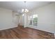 Bright living room with wood floors, large windows, and neutral walls, perfect for entertaining or relaxing at 2684 Sunberry Nw Ln, Concord, NC 28027