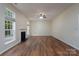Spacious living room featuring wood floors, a fireplace, and bright natural light, perfect for relaxing or entertaining at 2684 Sunberry Nw Ln, Concord, NC 28027