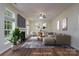Living room with a fireplace, large windows, and neutral colors, creating a comfortable and inviting space at 2684 Sunberry Nw Ln, Concord, NC 28027