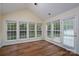 Charming sunroom featuring multiple windows, vaulted ceilings, and hardwood floors with access to outdoors at 2684 Sunberry Nw Ln, Concord, NC 28027