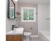 Bathroom featuring modern vanity, window with natural light and shower/bath combo at 2717 Springway Dr, Charlotte, NC 28205