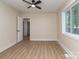 Bright bedroom with a ceiling fan, light beige walls, and a large window overlooking the backyard at 2717 Springway Dr, Charlotte, NC 28205