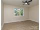 Bedroom features hardwood floors and window with views of trees at 2717 Springway Dr, Charlotte, NC 28205
