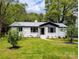 Ranch-style home with freshly cut green grass and a landscaped garden at 2717 Springway Dr, Charlotte, NC 28205