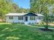 Beautifully renovated home with lush green lawn and fresh landscaping at 2717 Springway Dr, Charlotte, NC 28205