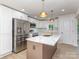 Modern kitchen features white cabinets, stainless steel appliances, and a stylish island with a sink at 2717 Springway Dr, Charlotte, NC 28205