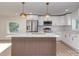 Modern kitchen featuring stainless steel appliances, a stylish island, and white cabinetry at 2717 Springway Dr, Charlotte, NC 28205