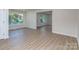 Spacious living room featuring large windows, modern flooring, and access to other rooms at 2717 Springway Dr, Charlotte, NC 28205