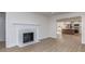 Cozy living room featuring a fireplace and an open view into the modern kitchen area at 2717 Springway Dr, Charlotte, NC 28205