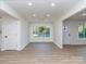 Bright living room with updated flooring, freshly painted walls, and large windows allowing for natural light at 2717 Springway Dr, Charlotte, NC 28205
