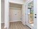 Mudroom with open closet space with shelves and a white door leading to the outside porch at 2717 Springway Dr, Charlotte, NC 28205