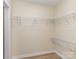 Walk-in closet with metal shelving system and hardwood floors at 2717 Springway Dr, Charlotte, NC 28205