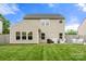 Spacious backyard featuring a green lawn, patio, and privacy fence at 3039 Keswick Ter, Indian Land, SC 29707