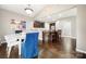 Bright dining area with hardwood floors next to a breakfast bar and open-concept kitchen at 3039 Keswick Ter, Indian Land, SC 29707