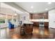 Open kitchen featuring hardwood floors, stainless steel appliances, and barstool seating at the island at 3039 Keswick Ter, Indian Land, SC 29707