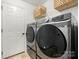 Practical laundry room featuring modern washer and dryer with ample storage at 3039 Keswick Ter, Indian Land, SC 29707