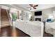 Open concept living room with a fireplace, tv, dark hardwood floors, stairs, and white sofas at 3039 Keswick Ter, Indian Land, SC 29707