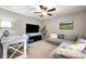 Spacious loft with neutral carpet, windows, comfortable seating plus a desk and tv at 3039 Keswick Ter, Indian Land, SC 29707