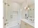 Bathroom features white vanity, frameless glass shower, stylish sconces, and a decorative floral arrangement at 3064 Selwyn Ave, Charlotte, NC 28209