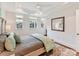 A bright primary bedroom offers natural light, wood floors, and neutral decor at 3064 Selwyn Ave, Charlotte, NC 28209