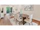 An open concept dining area showcases natural light and hardwood flooring at 3064 Selwyn Ave, Charlotte, NC 28209