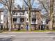 Beautiful multi-story townhouse with brick and siding facade, front balconies, and landscaped front yard at 3064 Selwyn Ave, Charlotte, NC 28209