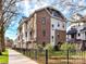 Charming townhome featuring a brick facade, white accents, fenced yard, and beautifully landscaped surroundings at 3064 Selwyn Ave, Charlotte, NC 28209
