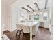 Bright, all-white kitchen with hardwood floors, marble island, modern appliances, and stylish lighting at 3064 Selwyn Ave, Charlotte, NC 28209