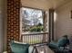 Inviting covered porch with brick accent, outdoor seating, and a view of a quiet street and mature trees at 3064 Selwyn Ave, Charlotte, NC 28209