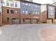 View of a row of modern townhomes featuring brick exteriors and attached garages on a paved street at 3064 Selwyn Ave, Charlotte, NC 28209