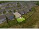 An aerial view showing the homes in a suburban neighborhood, featuring a well-maintained lawn and outdoor patio at 3129 Burnello Ct, Iron Station, NC 28080