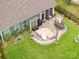 Aerial view of backyard featuring a patio with seating, a grill, and green lawn at 3129 Burnello Ct, Iron Station, NC 28080
