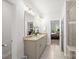 Bathroom with double sinks, granite countertops, a large mirror, and a tiled shower at 3129 Burnello Ct, Iron Station, NC 28080