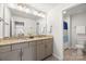 Bright bathroom featuring a double vanity with granite countertop and a separate toilet area at 3129 Burnello Ct, Iron Station, NC 28080