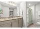 Well-lit bathroom featuring a vanity with granite countertops, a mirror, and a shower with a decorative curtain at 3129 Burnello Ct, Iron Station, NC 28080