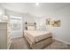 Bright bedroom with neutral walls features a cozy bed with a decorative comforter, creating a relaxing and inviting space at 3129 Burnello Ct, Iron Station, NC 28080