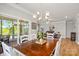 Charming dining room featuring a rustic wooden table, stylish chandelier and access to the cozy living area at 3129 Burnello Ct, Iron Station, NC 28080